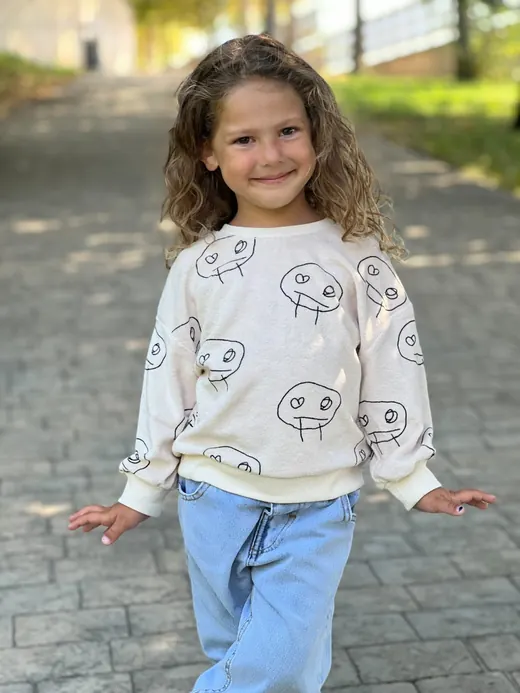 White printed sweatshirt with blue childrenswear trousers