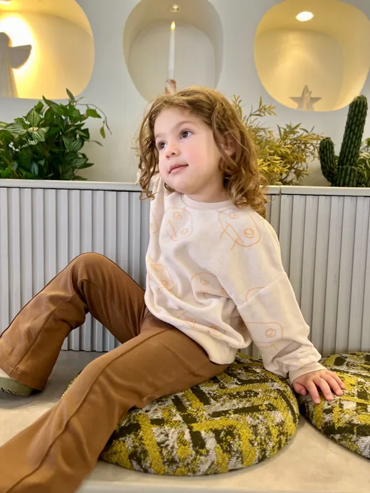 Cream sweatshirt with brown childrenswear trousers