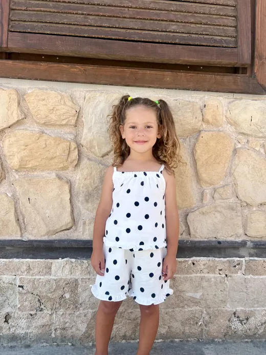 White polka-dot sleeveless childrenswear dress