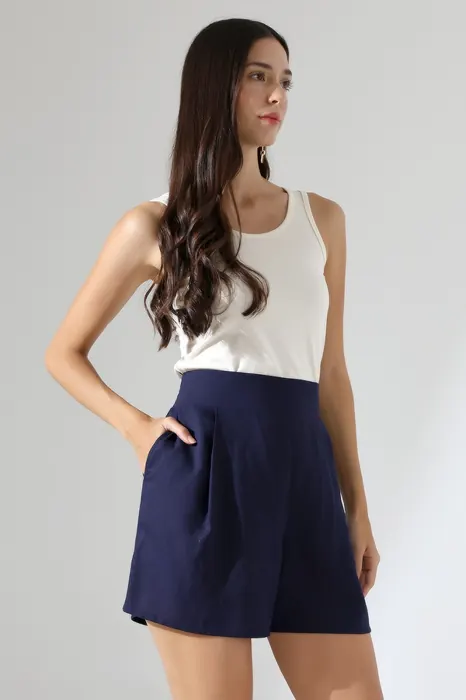 White sleeveless top with navy womenswear shorts