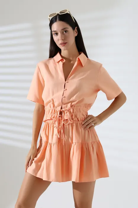 Peach satin womenswear shirt and shorts set